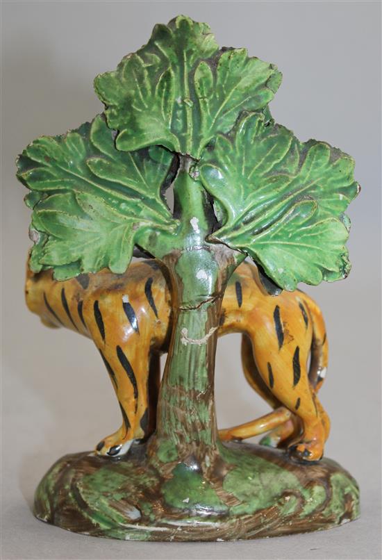 An early 19th century Staffordshire pearlware figure of an arched tiger, 13.5cm, damages